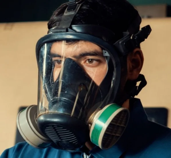 Safety manager reviewing a written respiratory protection program with a worker