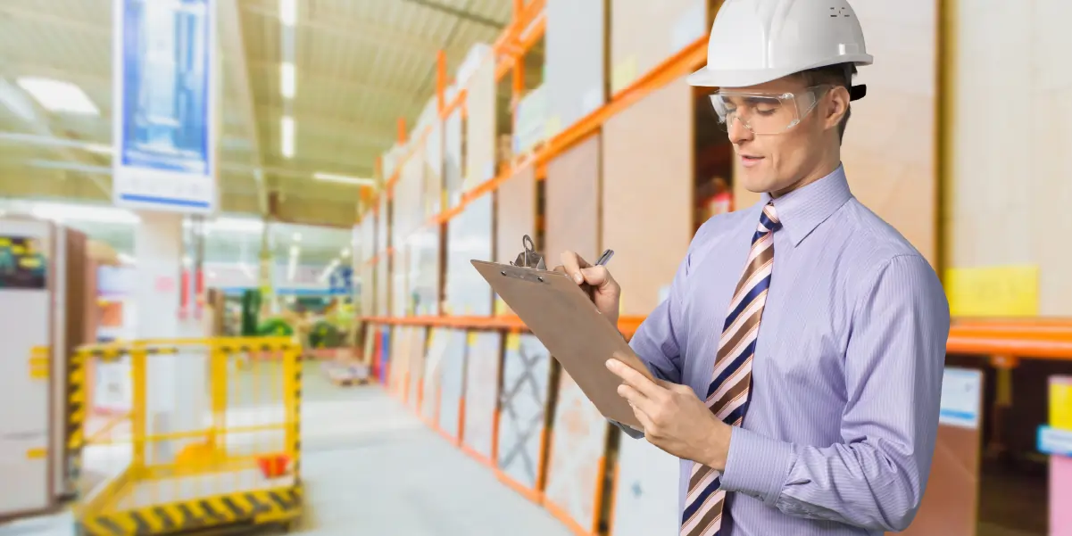 OSHA compliance officer conducting a workplace walkthrough inspection of a manufacturing facility
