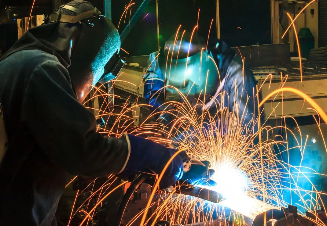 Welder in PAPR using local exhaust ventilation while welding stainless steel